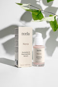 Nora — Exosome & Niacinamide Serum by Norla, box and bottle with a botanical leaf